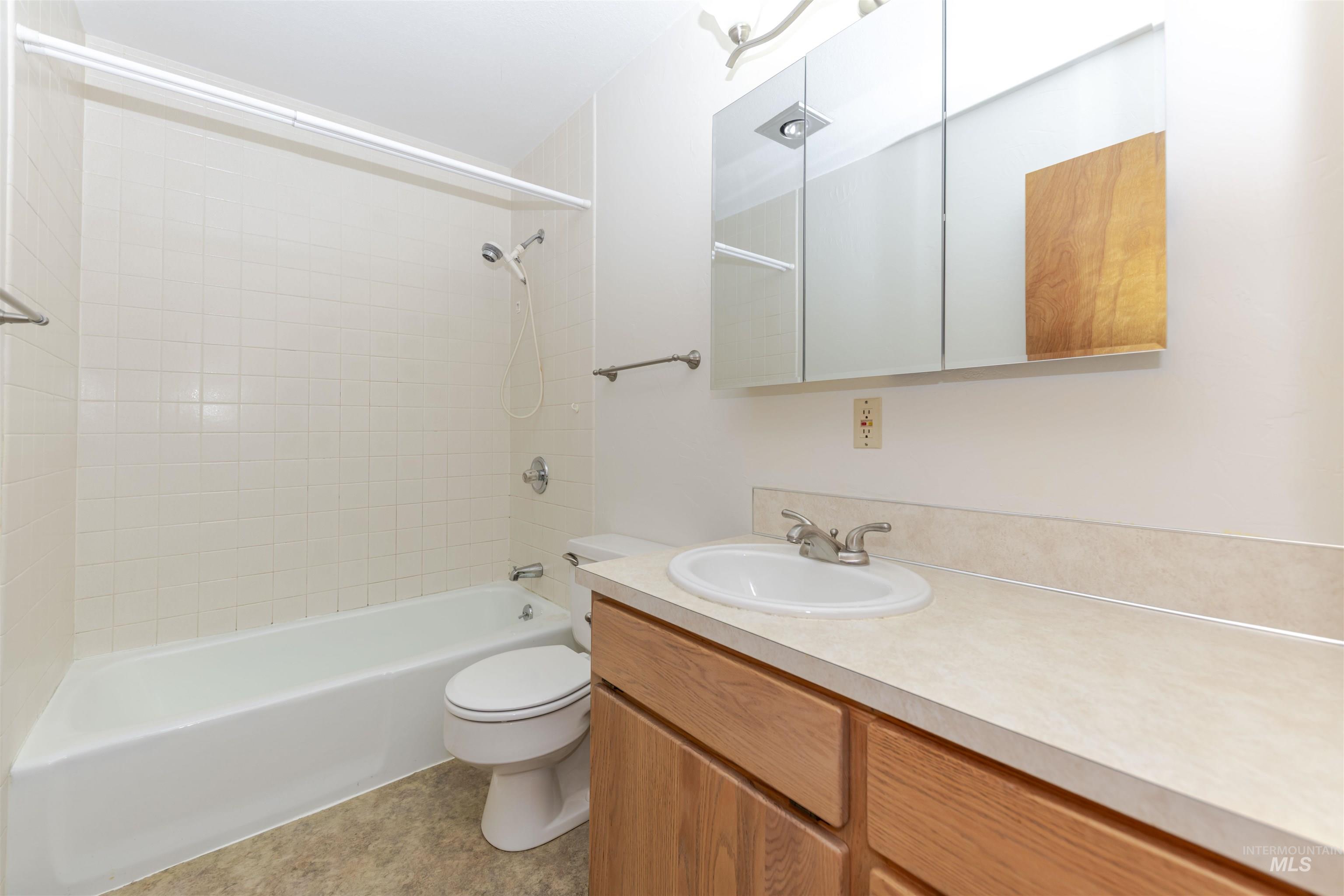 Full bathroom with vanity and washtub / shower combination