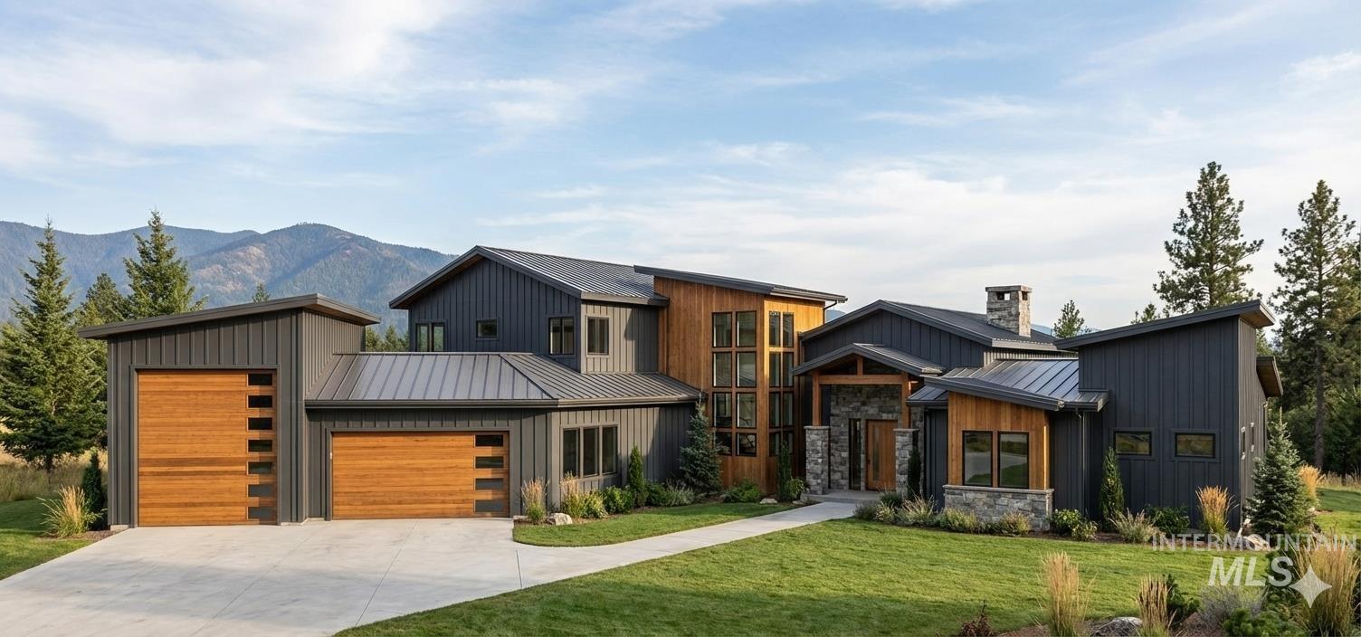 View of front of home featuring a standing seam roof, a metal roof, and concrete driveway