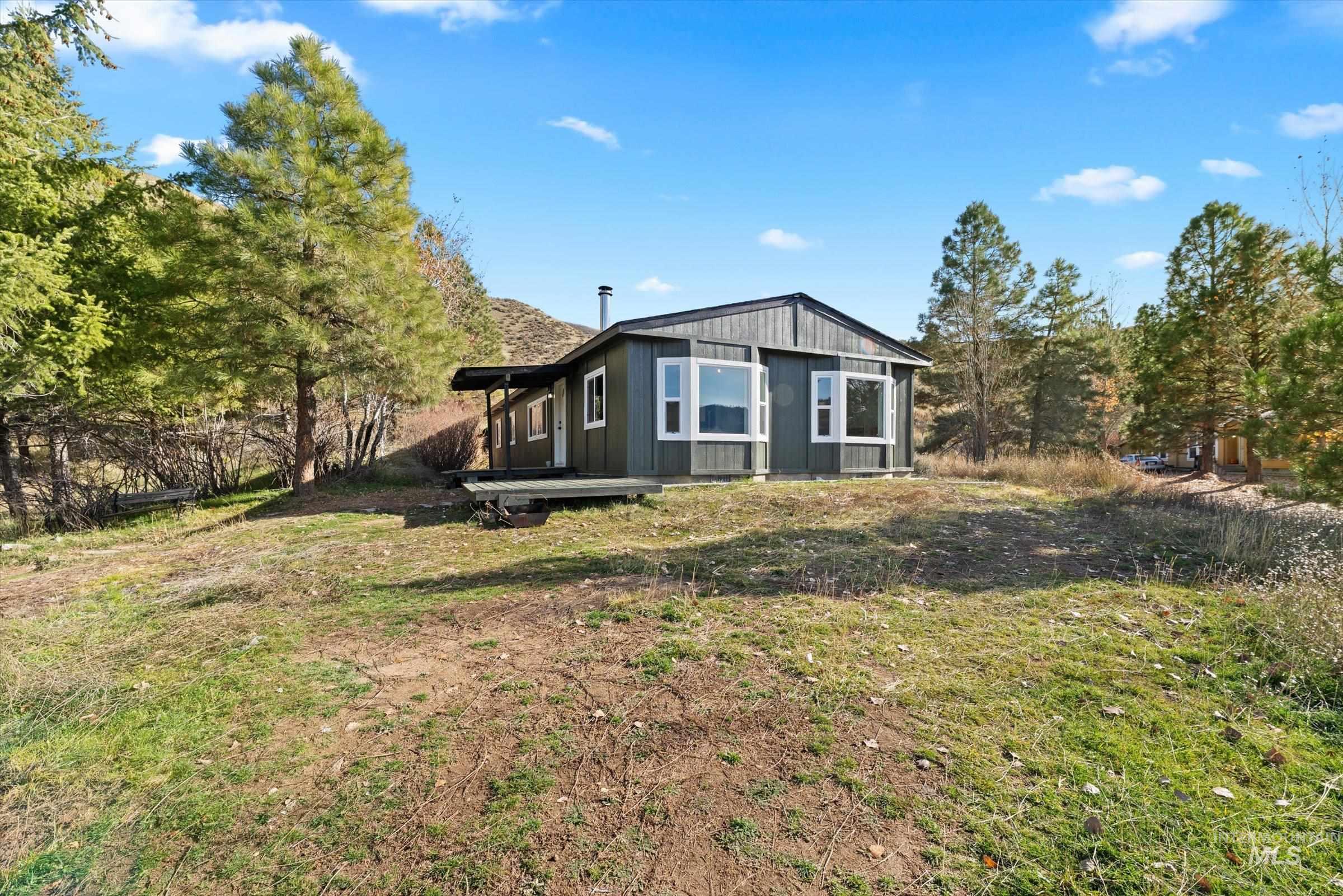 Back of property with a lawn