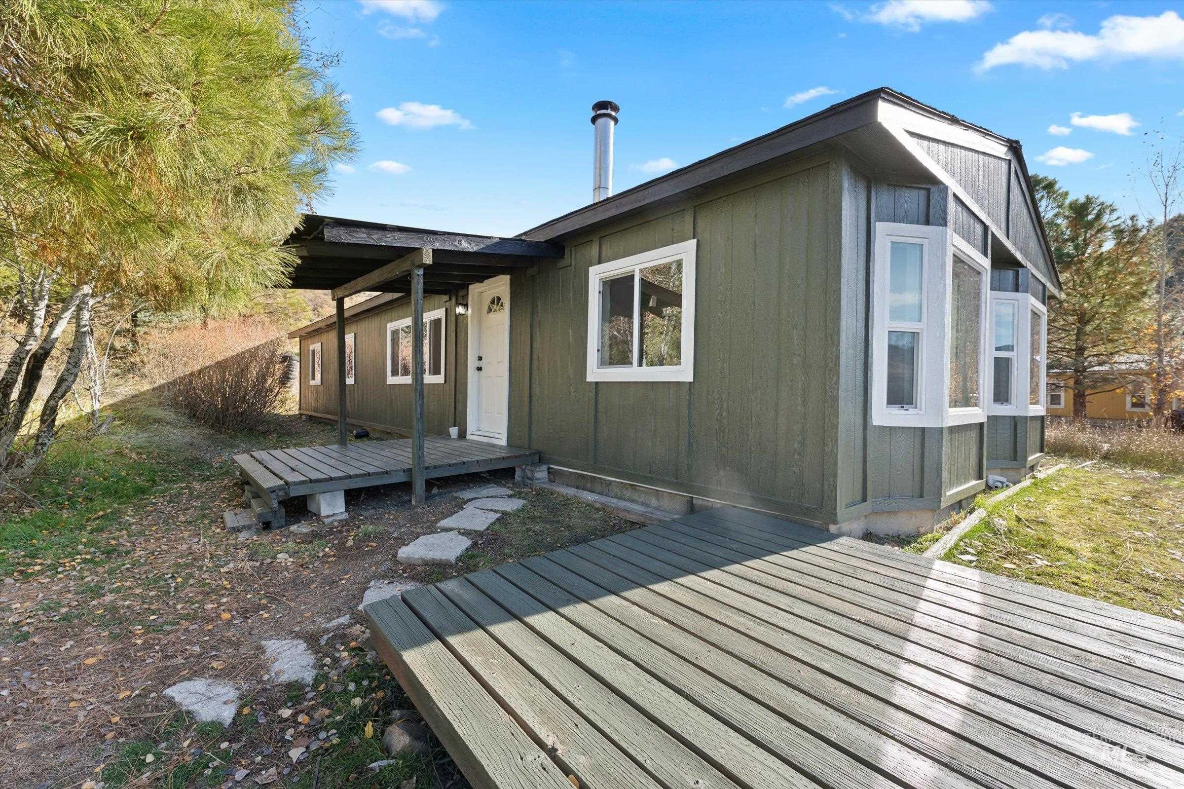 Back of house featuring a wooden deck