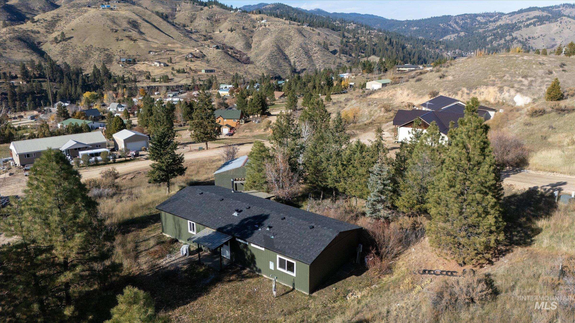 Aerial view of property's location featuring a mountainous background