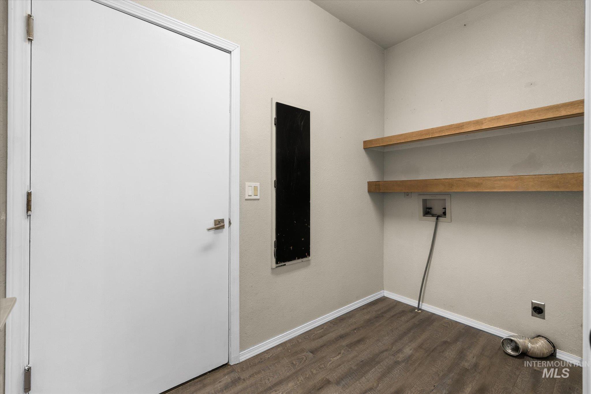 Laundry area featuring dark wood-style flooring, washer hookup, and hookup for an electric dryer