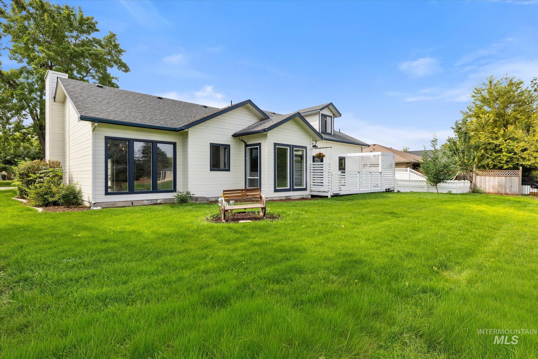 Back of property featuring roof with shingles and a chimney