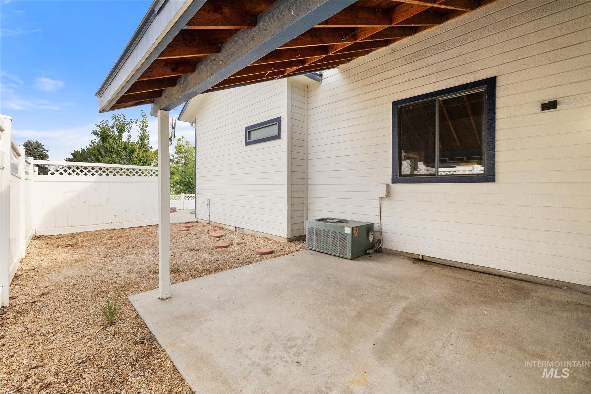 Fenced backyard with a patio