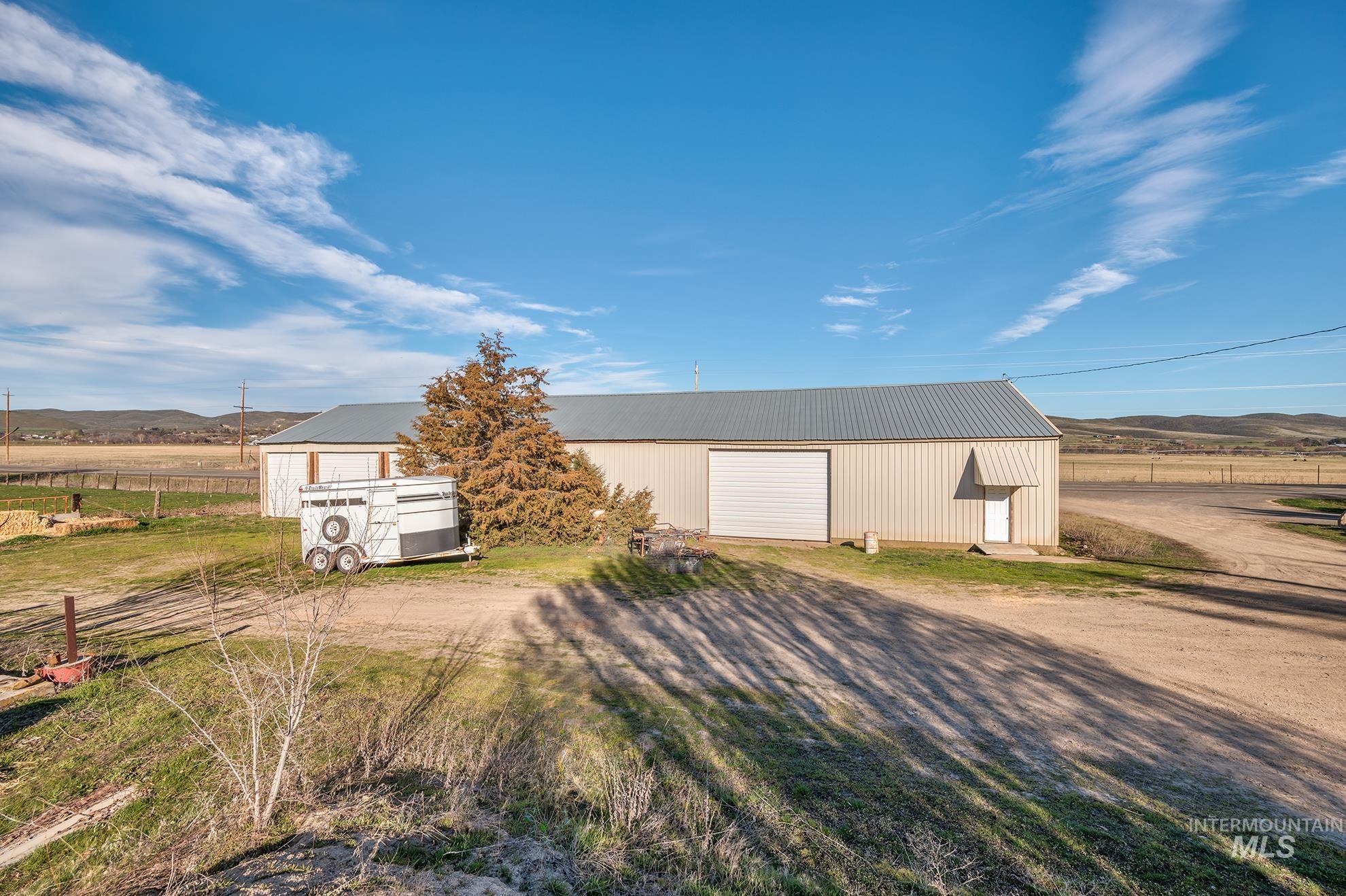 View of outbuilding with a mountain view, a view of rural / pastoral area, and driveway