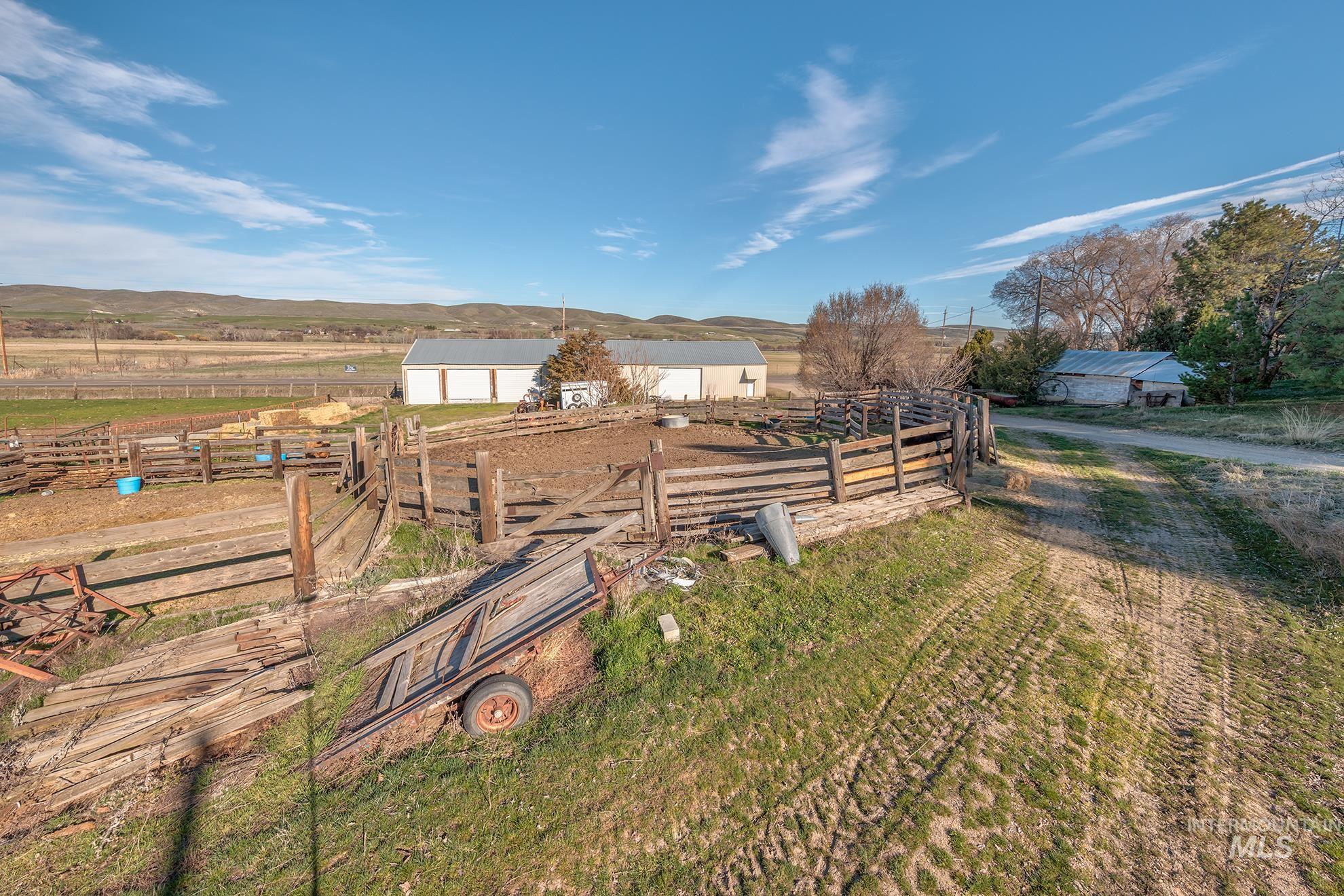 View of yard with a view of rural / pastoral area, an outdoor structure, a detached garage, and a mountain view