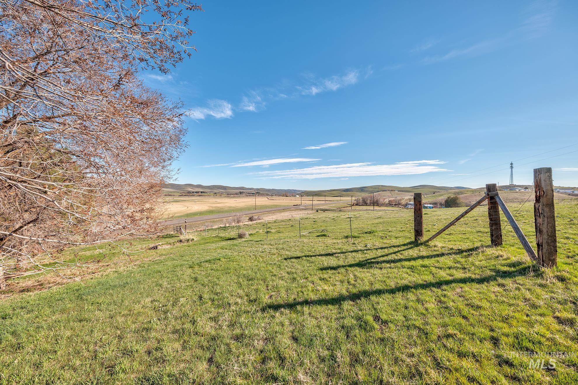 View of green lawn featuring a rural view and a mountain view