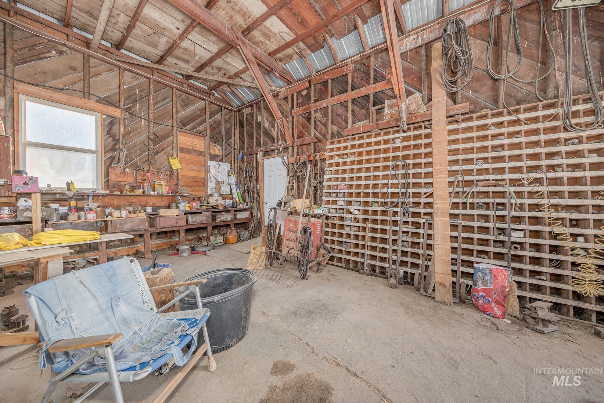 Miscellaneous room with a workshop area and unfinished concrete floors