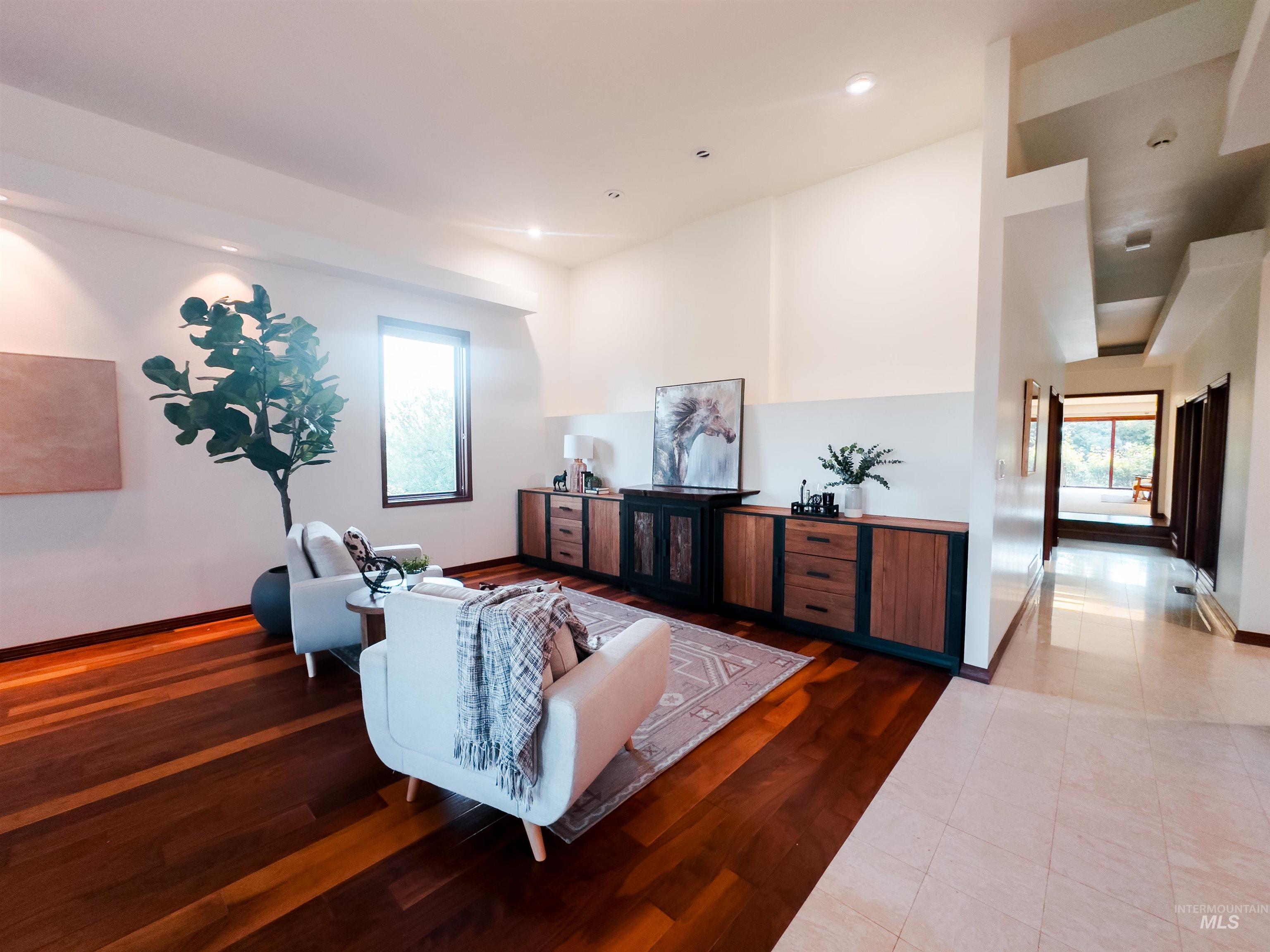 Living room with wood finished floors, healthy amount of natural light, and recessed lighting