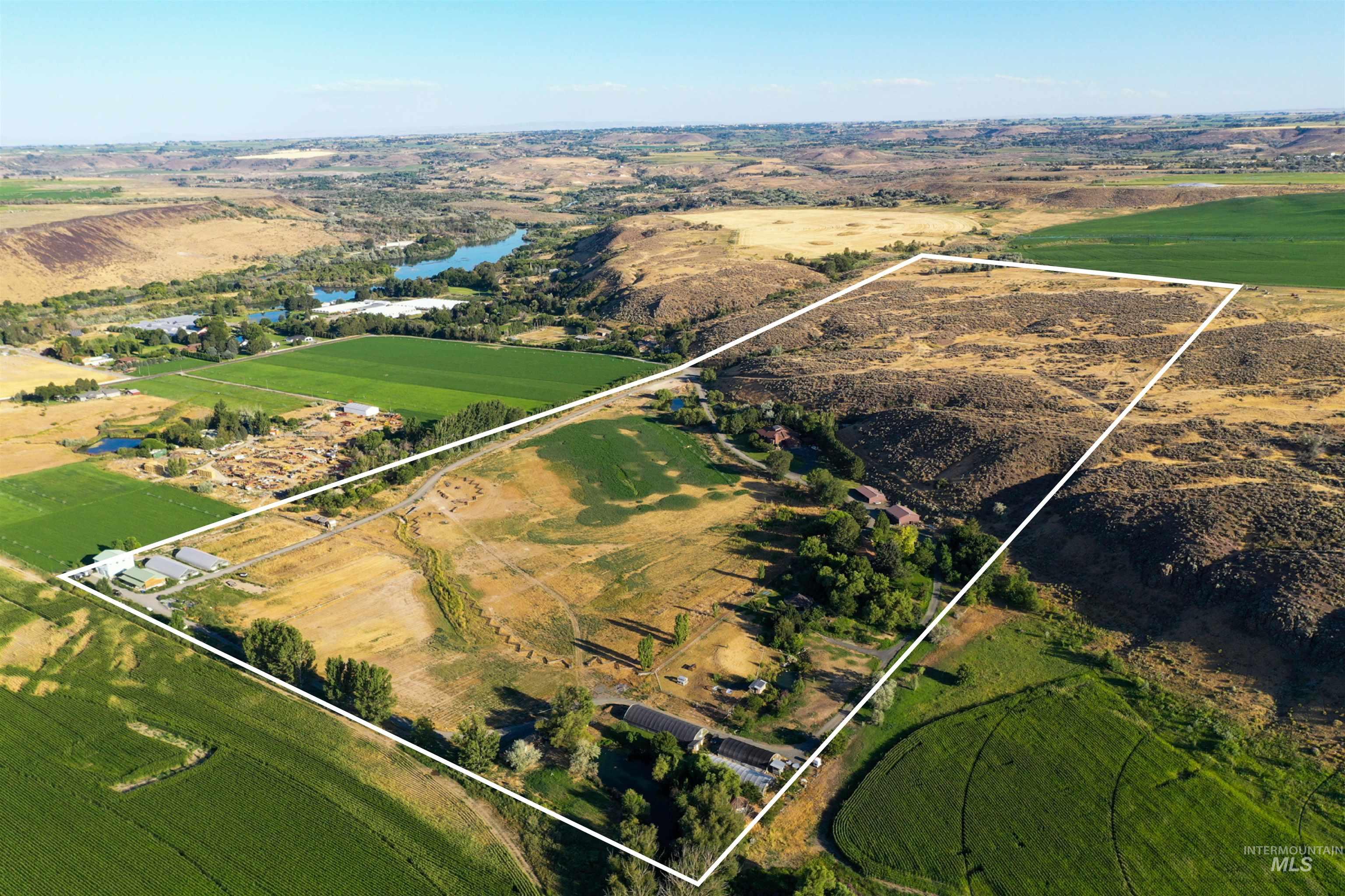 Overview of rural landscape with a large body of water and property boundaries highlighted