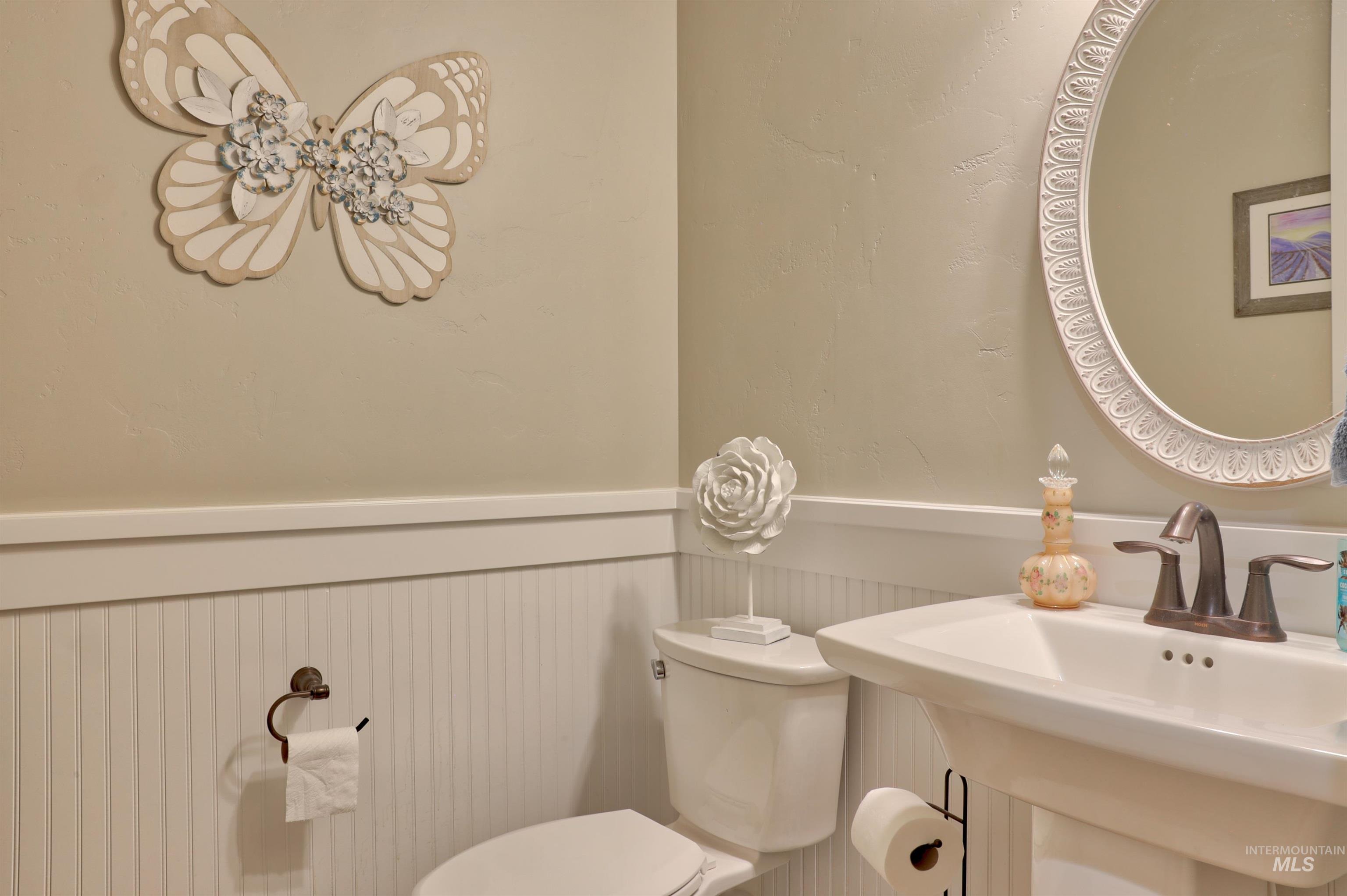 Bathroom featuring wainscoting and toilet
