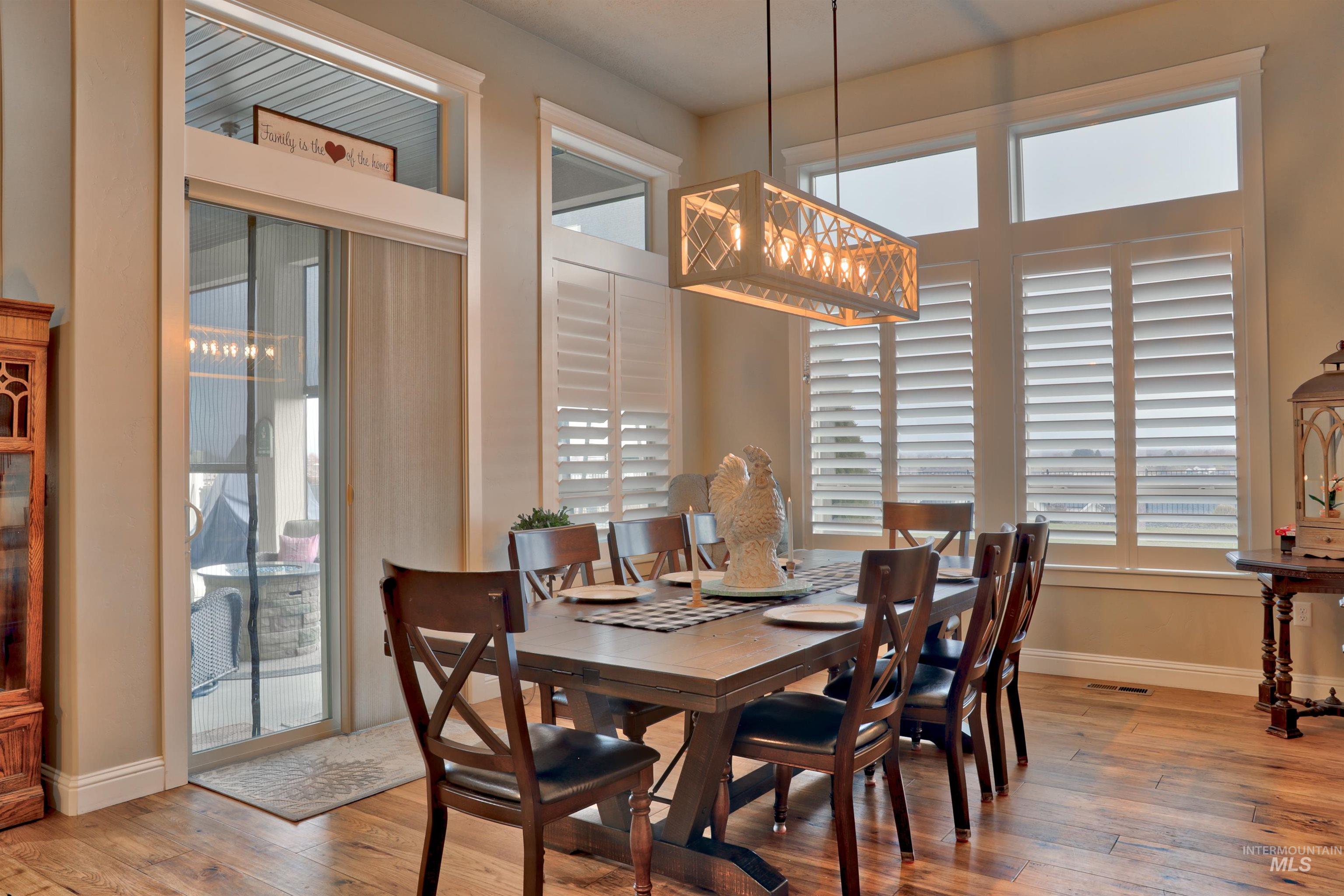 Dining room with light wood-style flooring and healthy amount of natural light