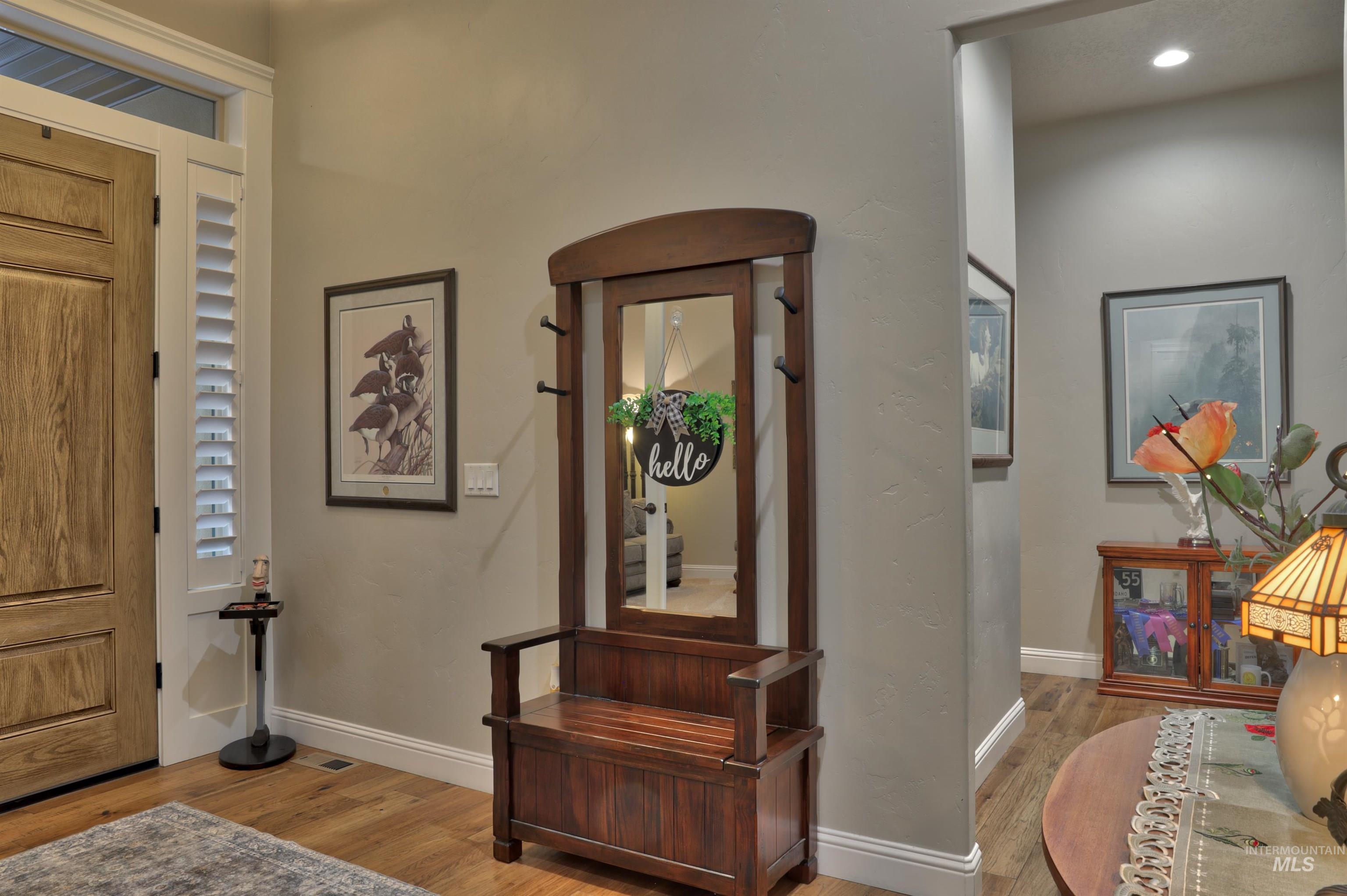 Foyer entrance featuring wood finished floors