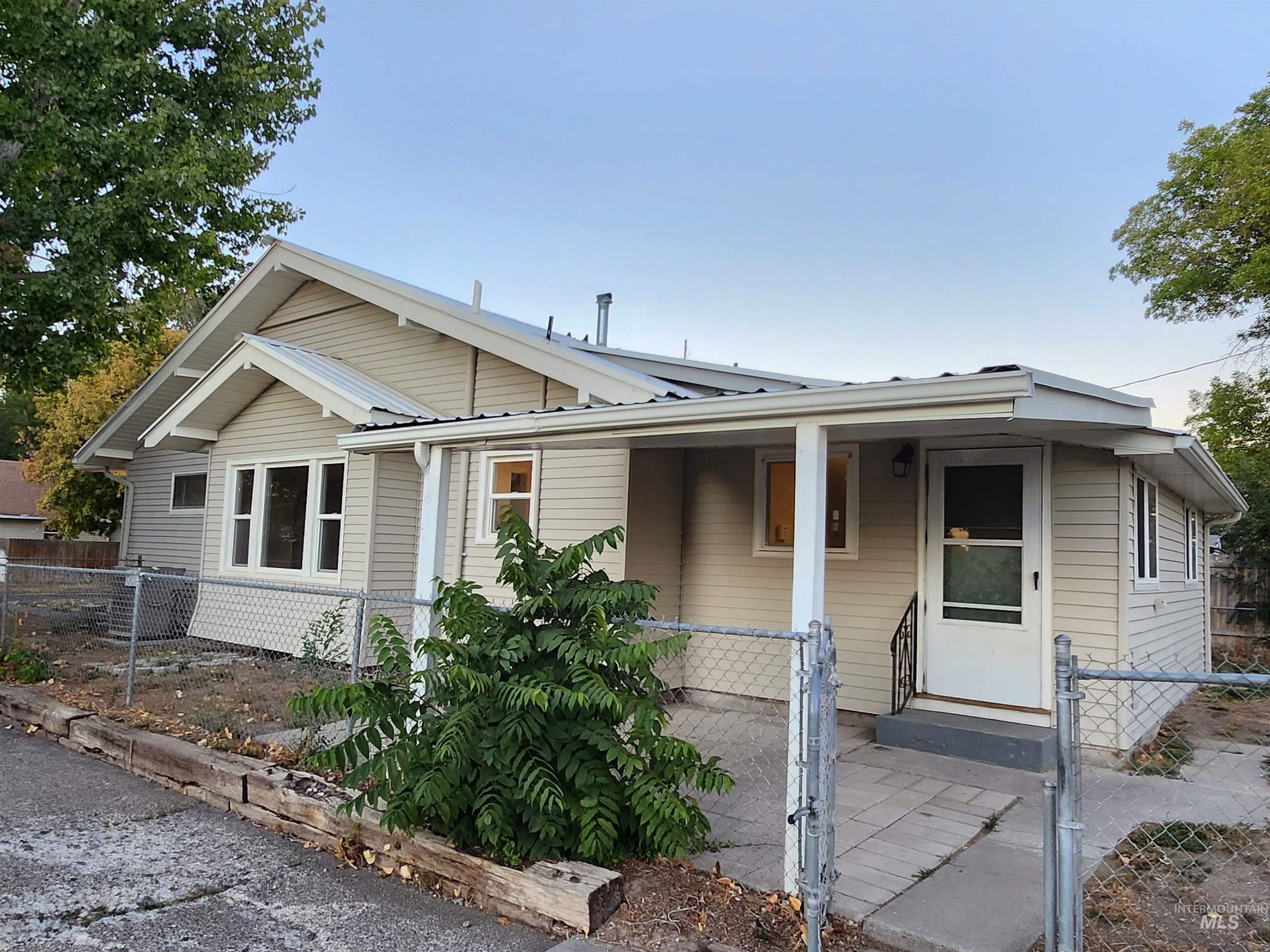 Bungalow-style house featuring a gate and a porch