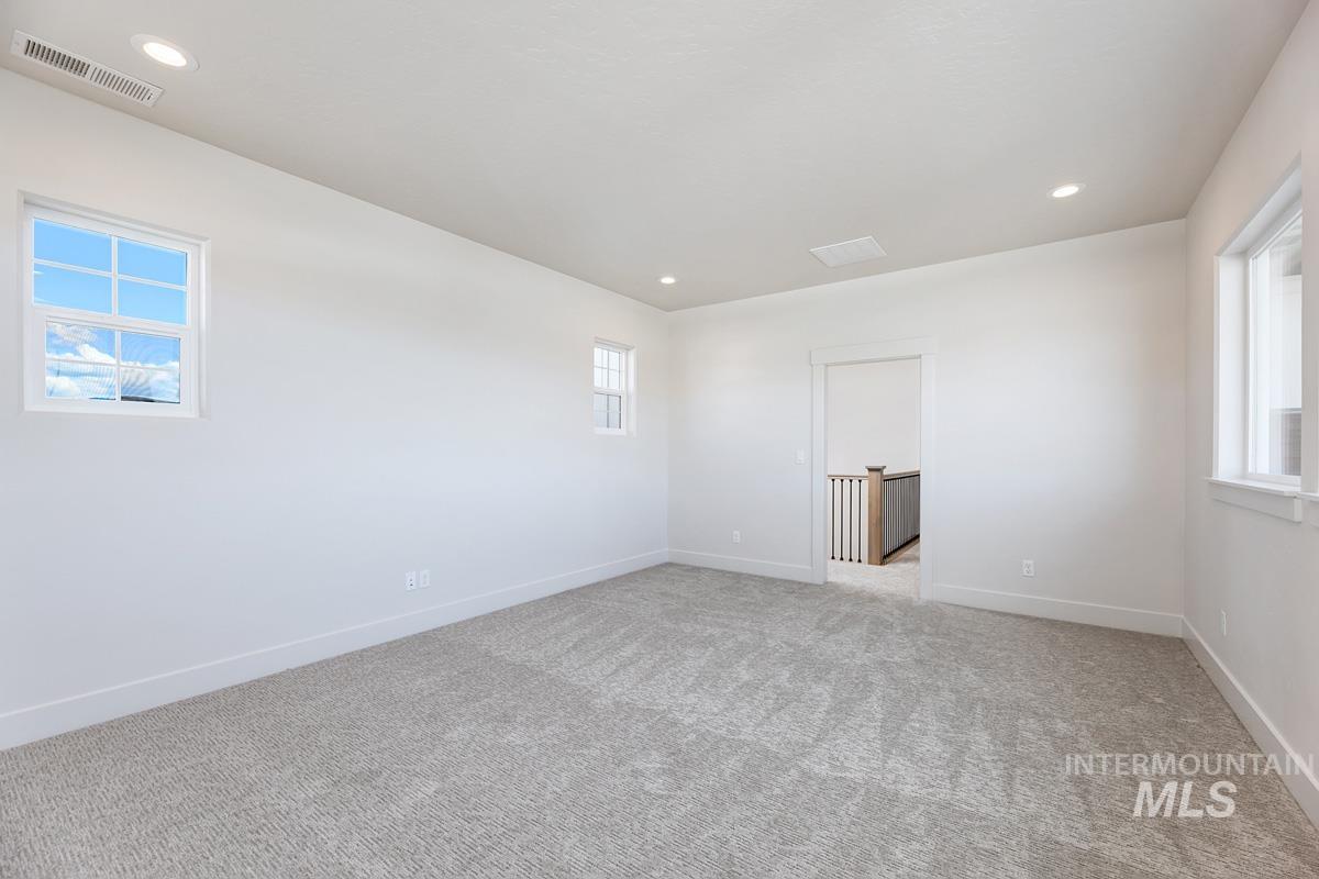 Spare room featuring recessed lighting and light colored carpet