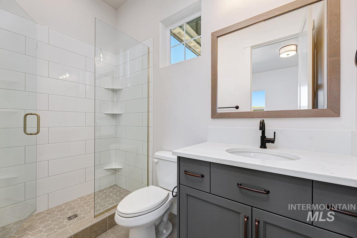 Full bathroom with a stall shower and vanity