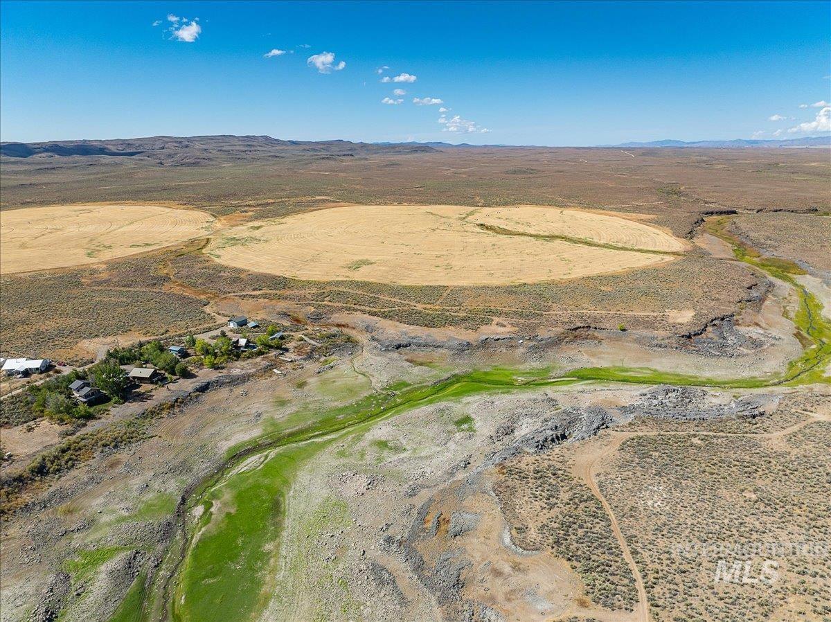 Aerial view of property's location featuring a mountainous background and rural landscape