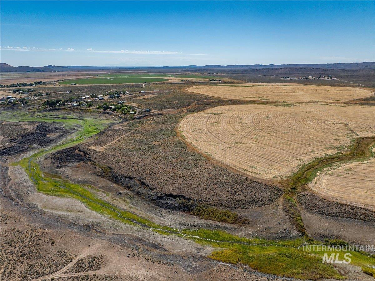 Aerial overview of property's location with mountains and rural landscape