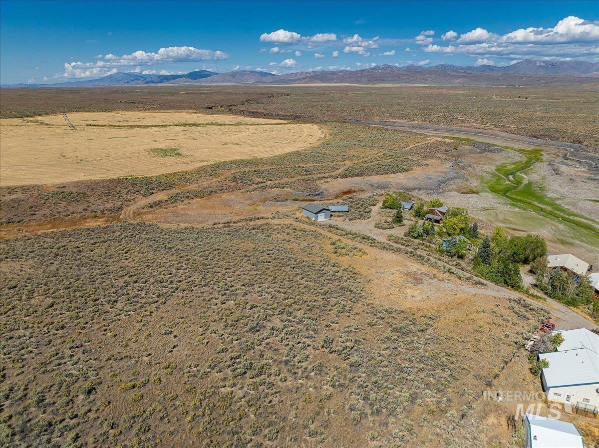 Overview of rural landscape featuring a mountain backdrop and a desert landscape