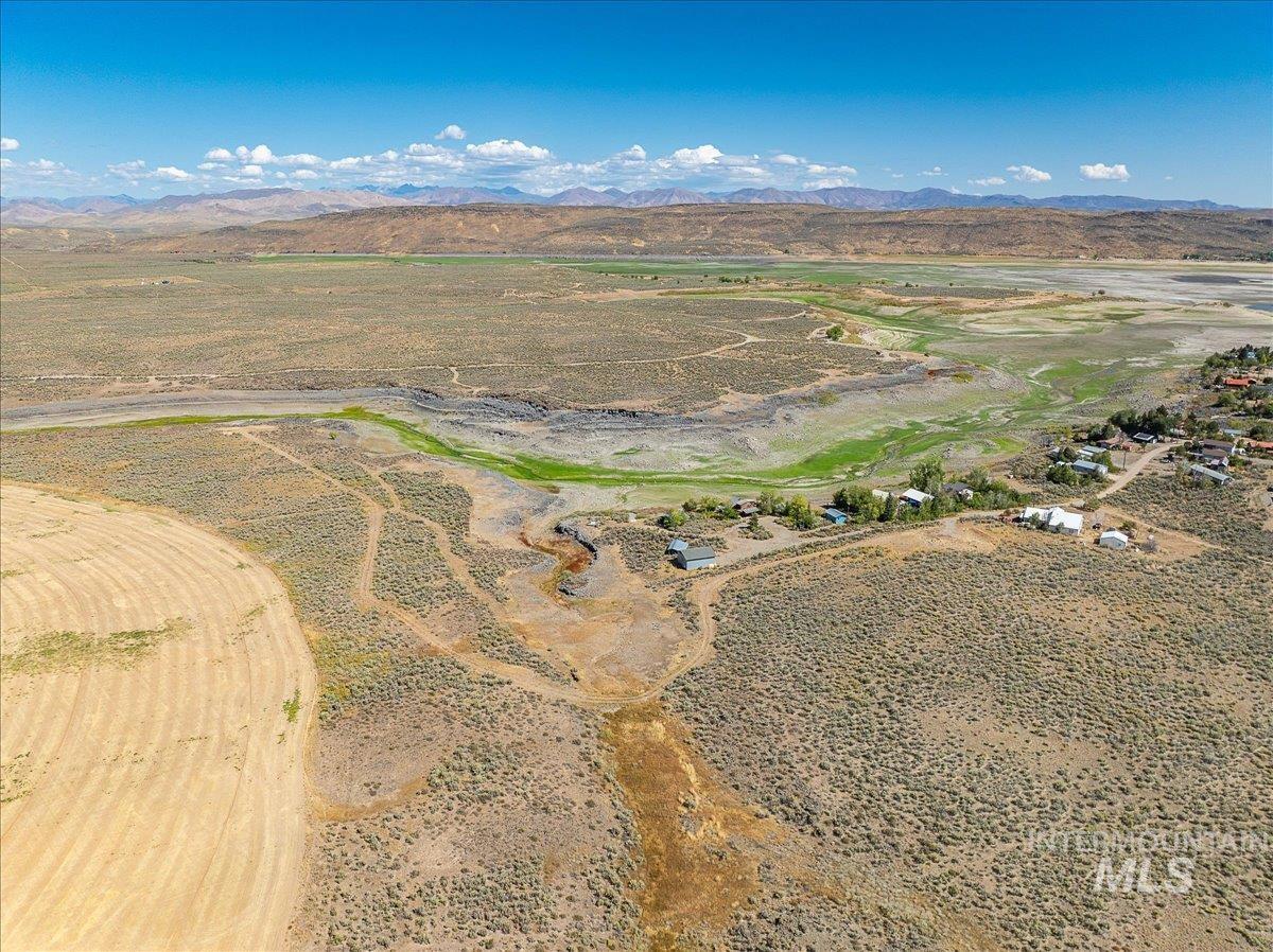 Aerial view of property's location featuring rural landscape and a mountainous background