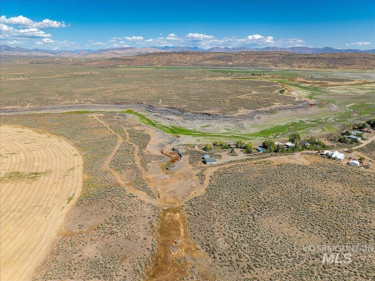 Aerial overview of property's location featuring rural landscape and mountains