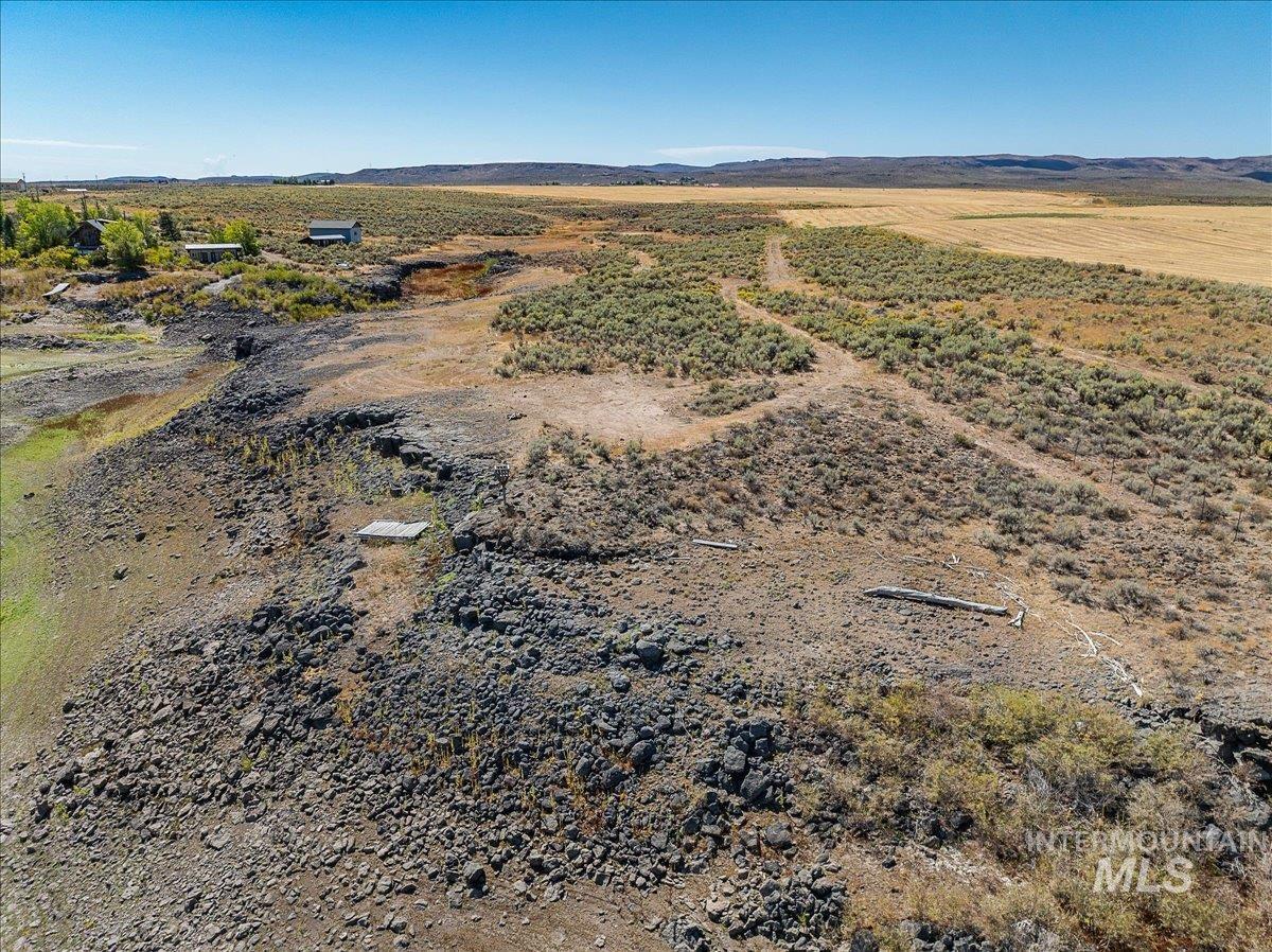 View of rural area with a desert landscape and a mountain backdrop