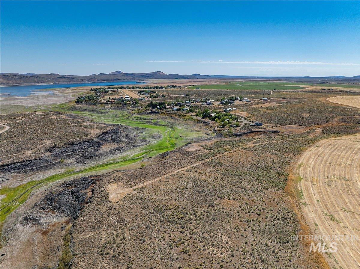 Aerial view of sparsely populated area with a water and mountain view