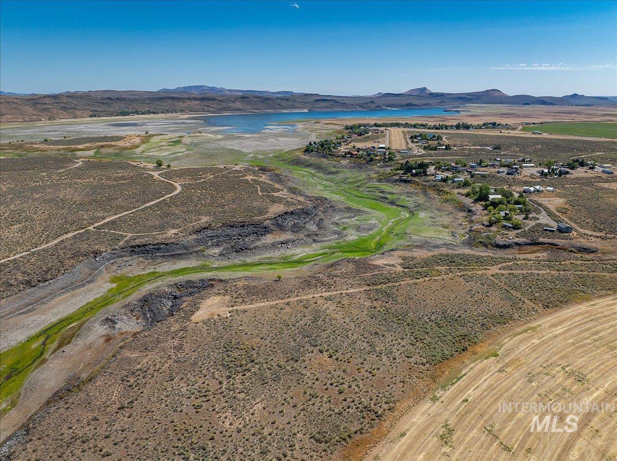 Aerial view of property's location featuring a water and mountain view