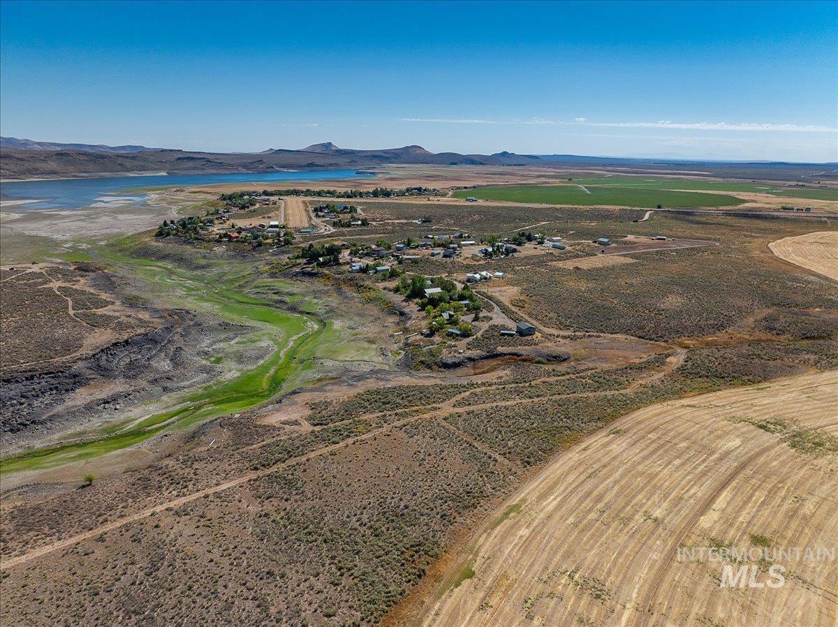Aerial overview of property's location with a water and mountain view and rural landscape