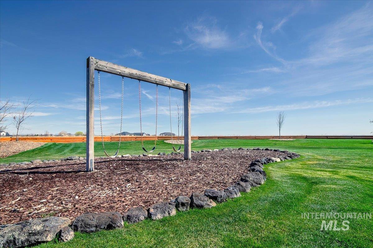Outdoor swing set featuring a natural wood frame and three swings