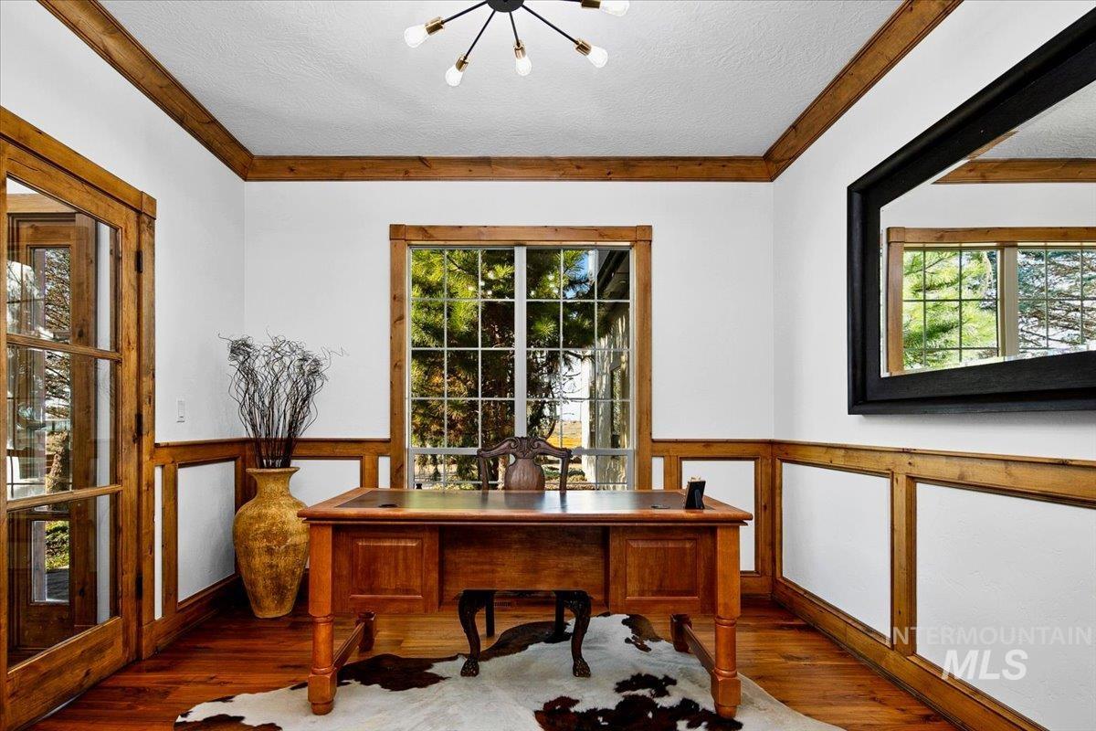 Wood-finish flooring with wainscoting and natural wood trim accents