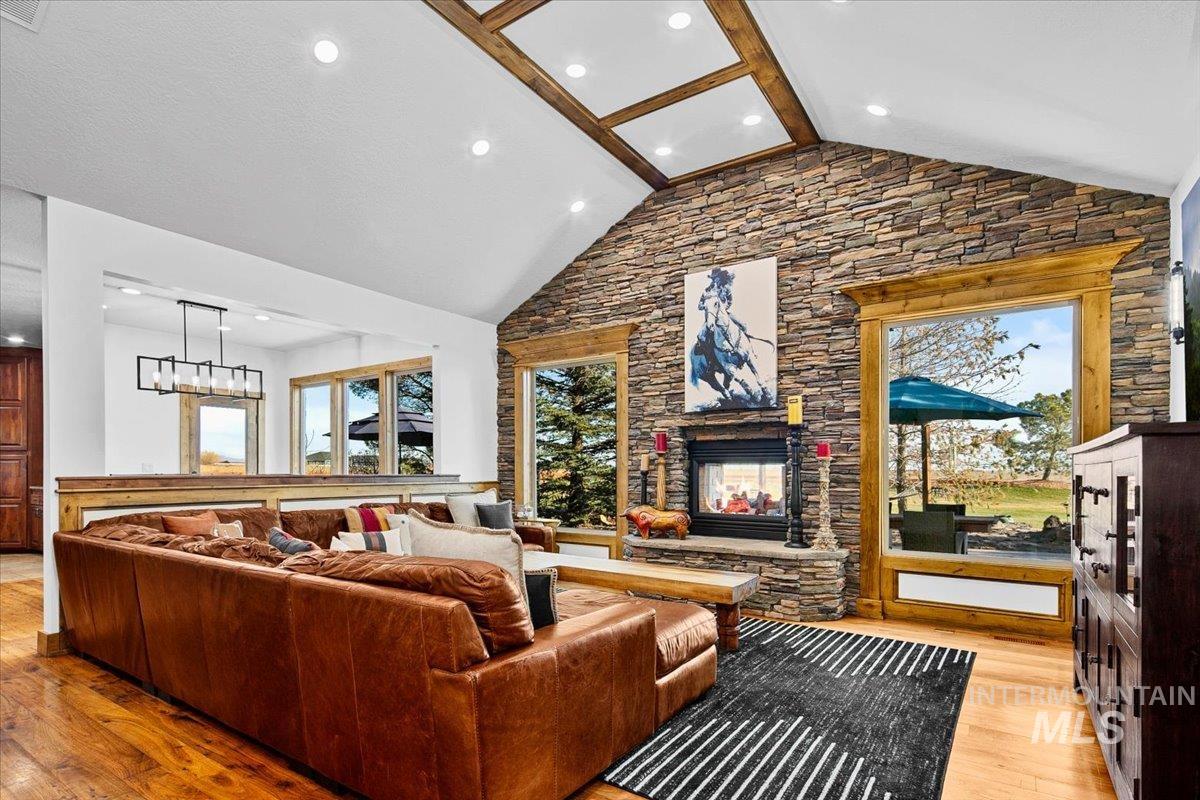Vaulted ceiling with exposed wood beams and recessed lighting