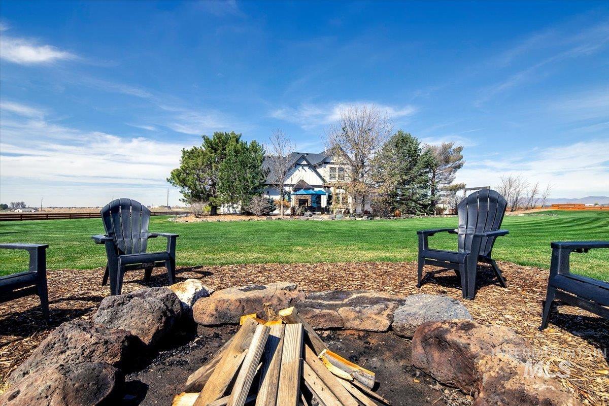 Outdoor fire pit area with stone surround and wood chip base