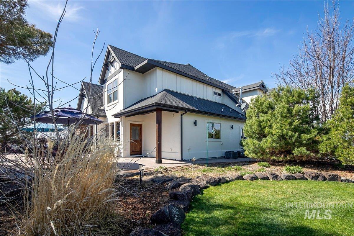 White exterior with dark trim and board and batten accents