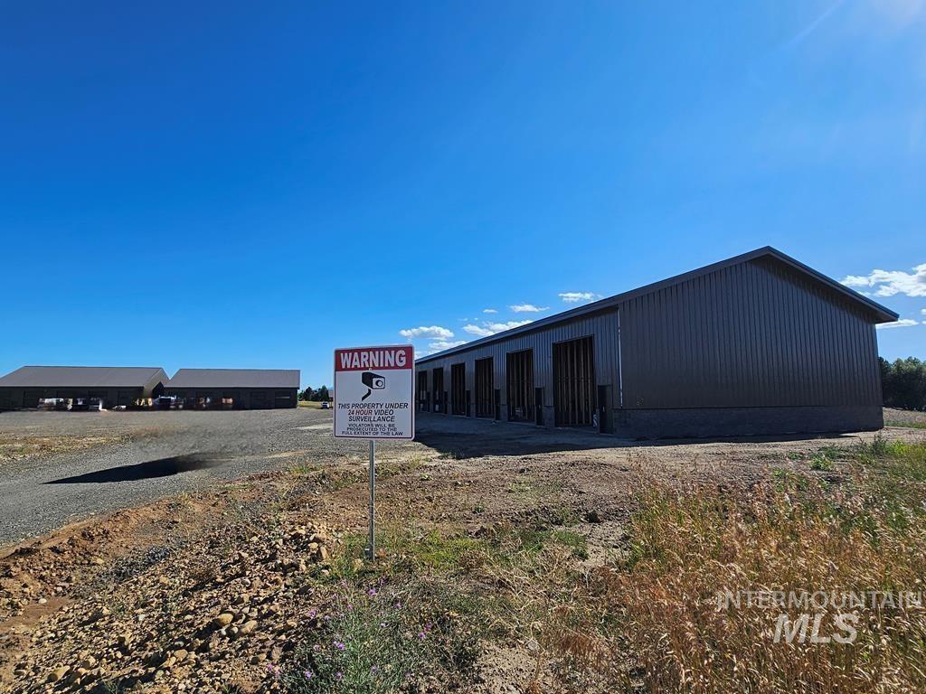 View of building exterior with an outbuilding