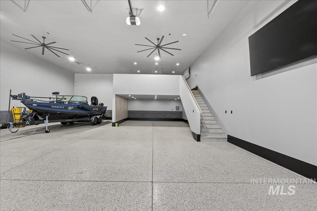 Garage featuring baseboards and a garage door opener