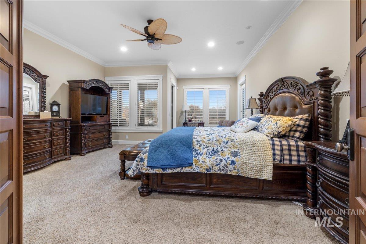 Bedroom with ornamental molding, light colored carpet, a ceiling fan, and recessed lighting