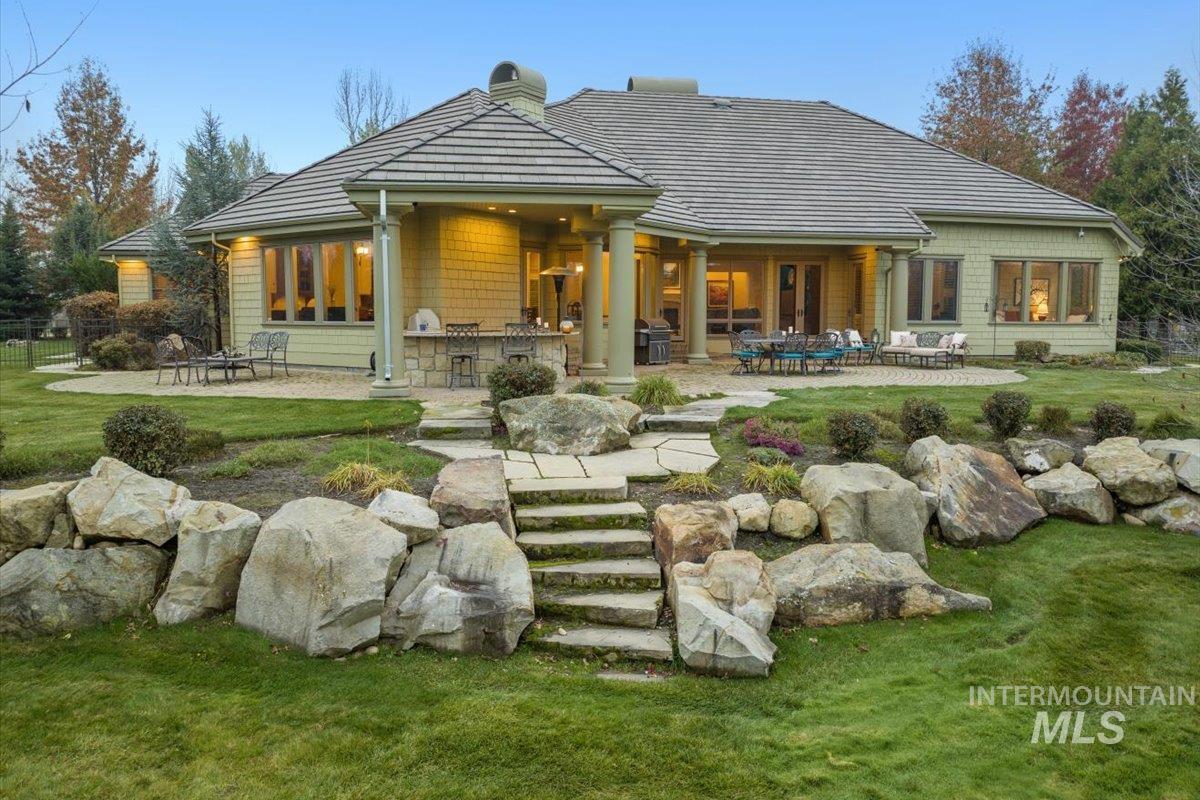 Back of house featuring a patio, exterior kitchen, a yard, and a chimney