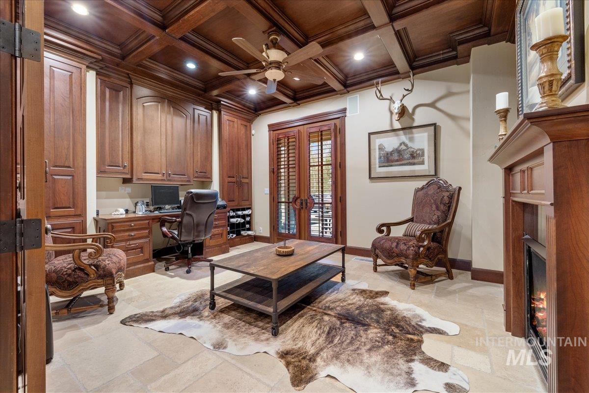 Home office featuring french doors, a wood ceiling with exposed beams, ornamental molding, ceiling fan, and coffered ceiling
