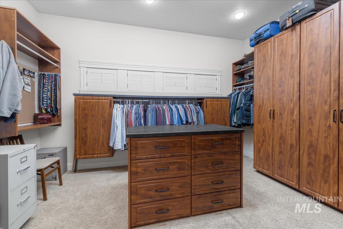 Spacious closet with light carpet