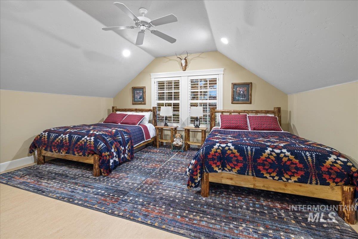 Bedroom with lofted ceiling and ceiling fan