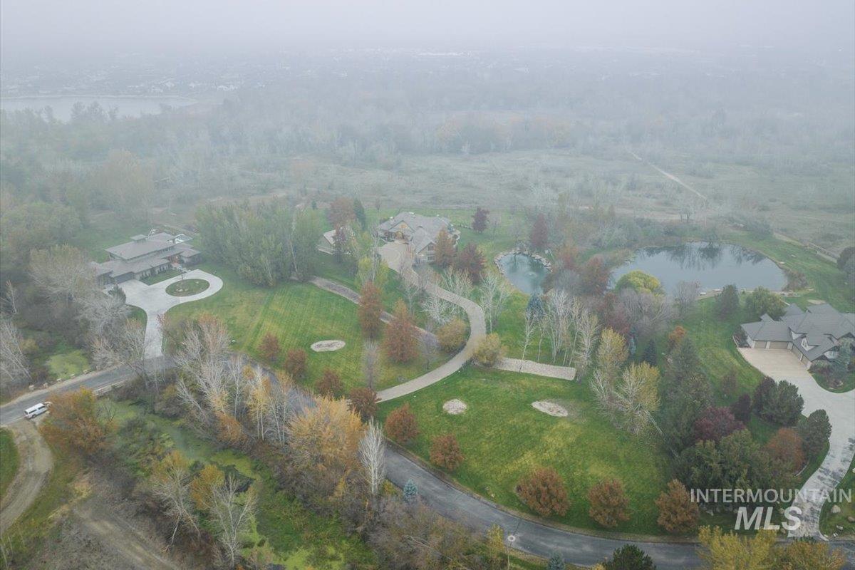 Aerial view of property and surrounding area featuring a large body of water