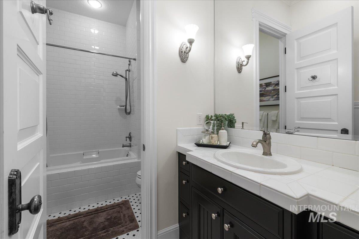 Full bath with vanity and tiled shower / bath combo