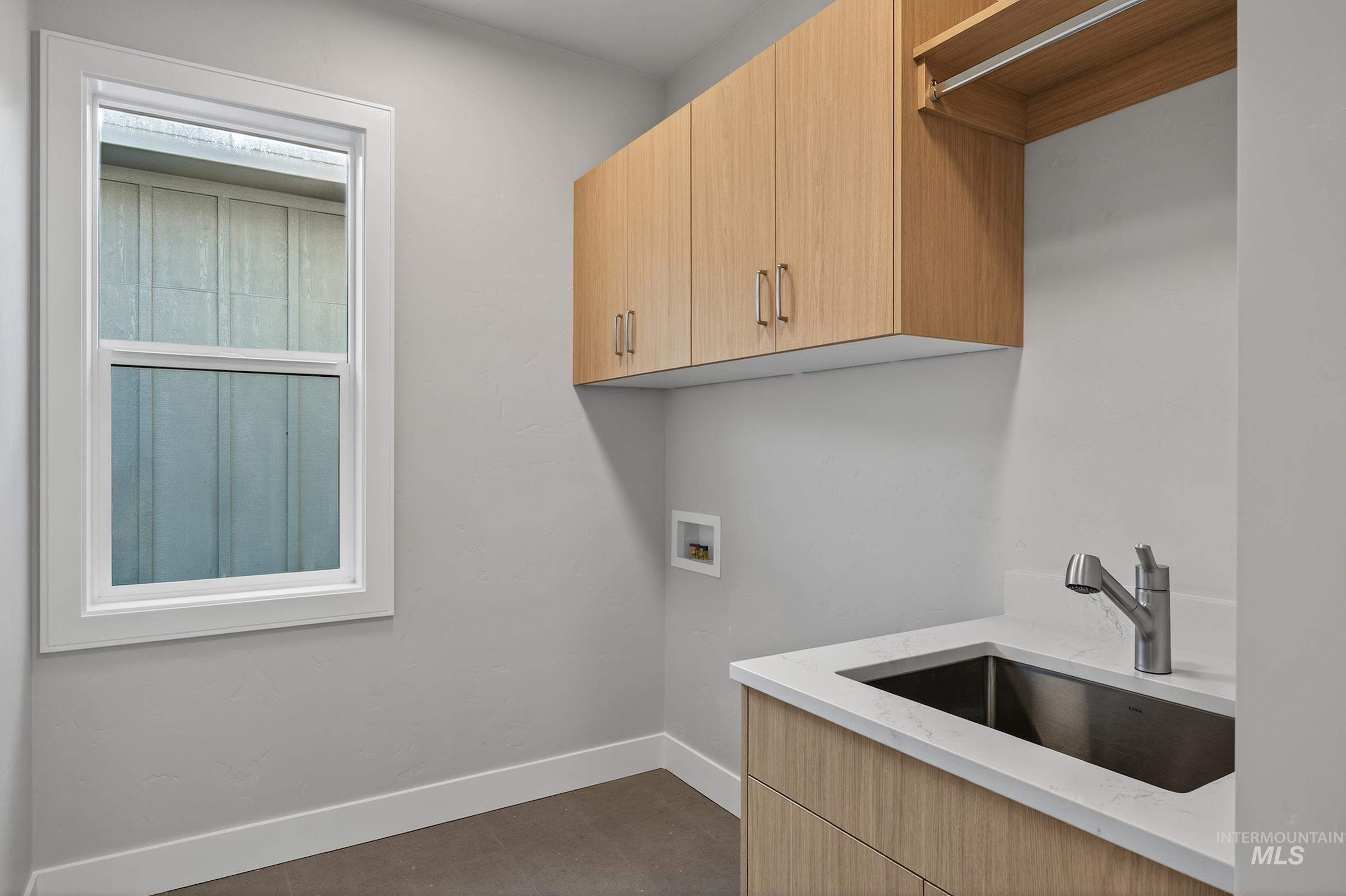 Laundry area with hookup for a washing machine and cabinet space