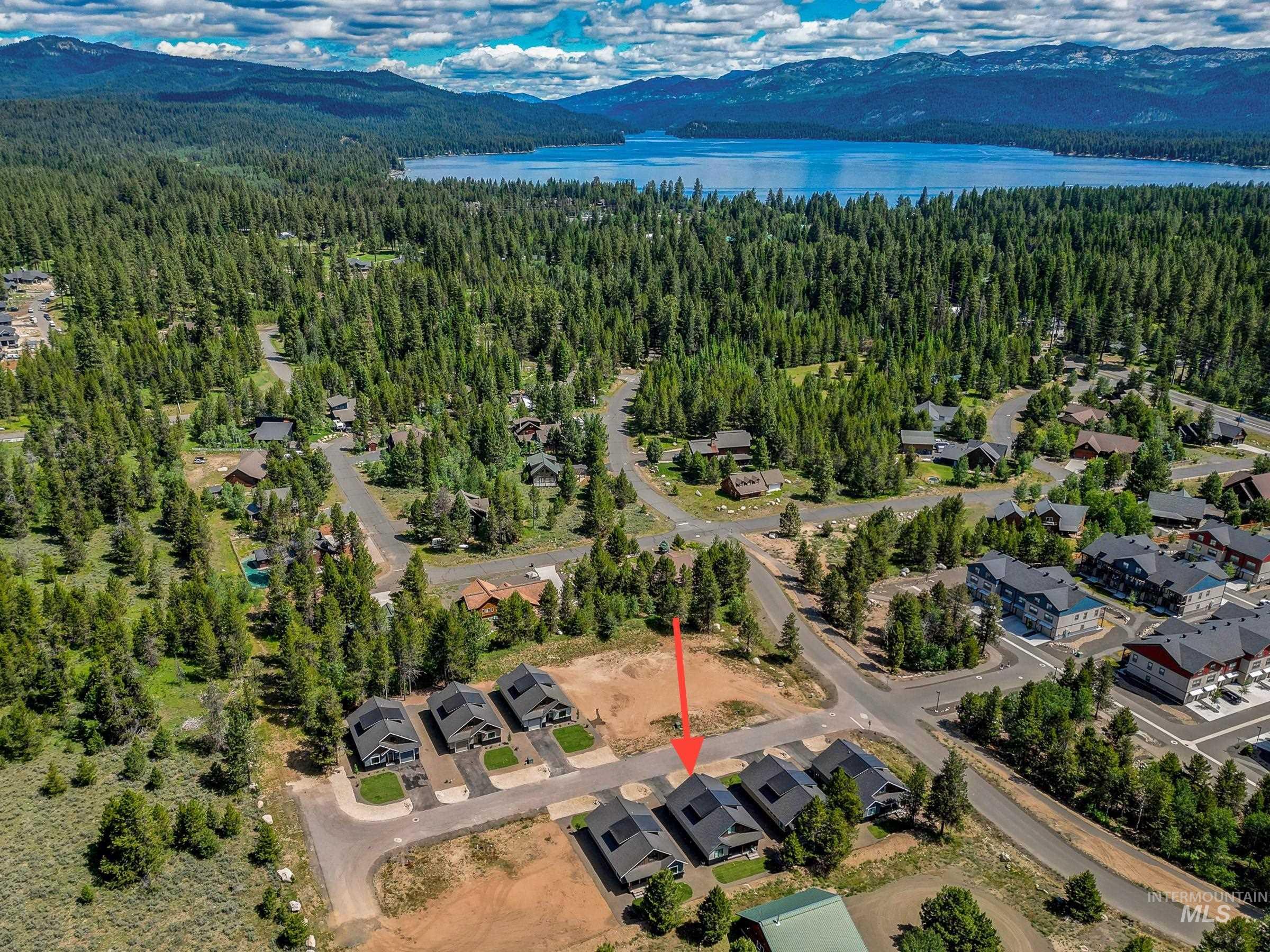View of property location with a water and mountain view and a forest