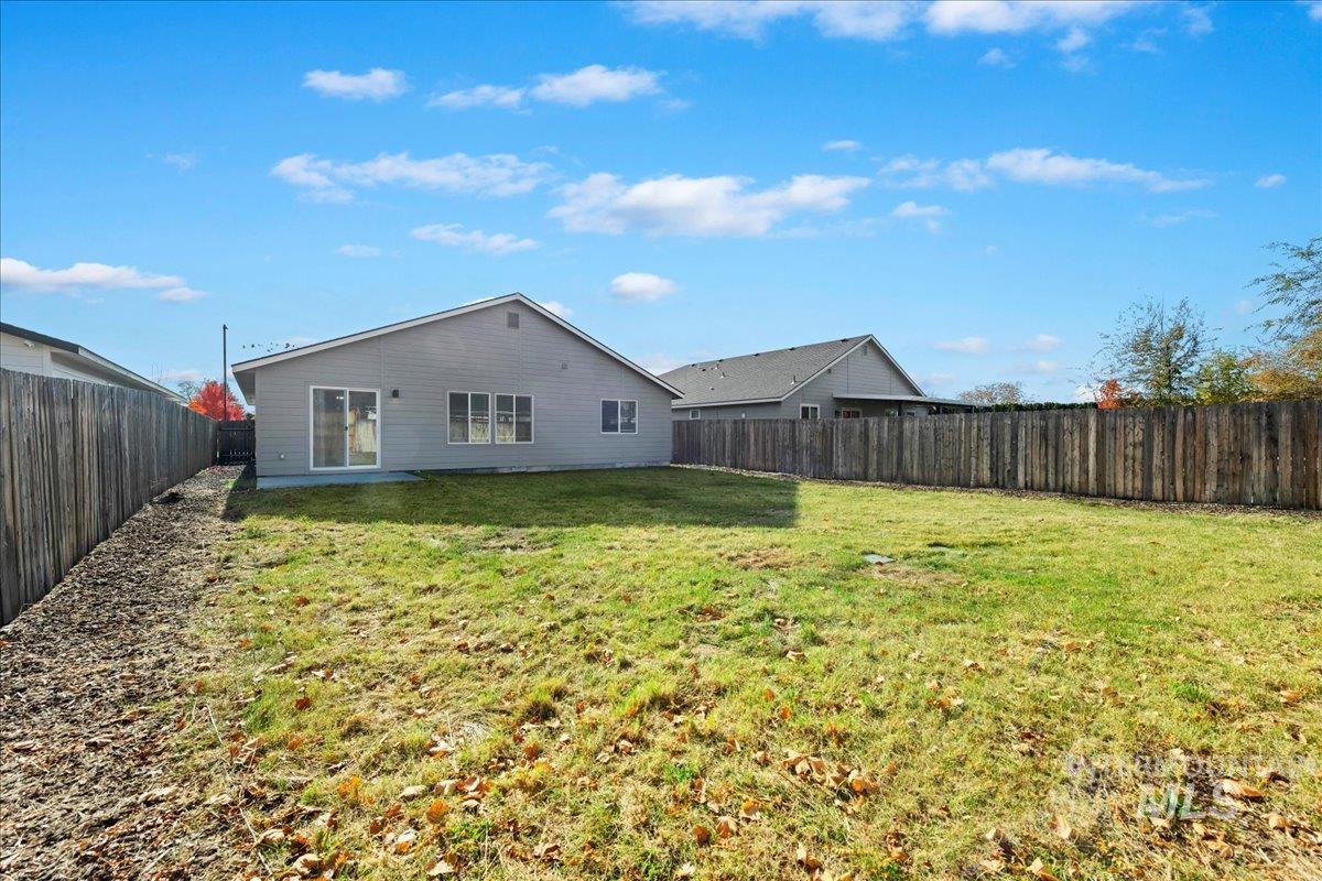 Rear view of property featuring a fenced backyard