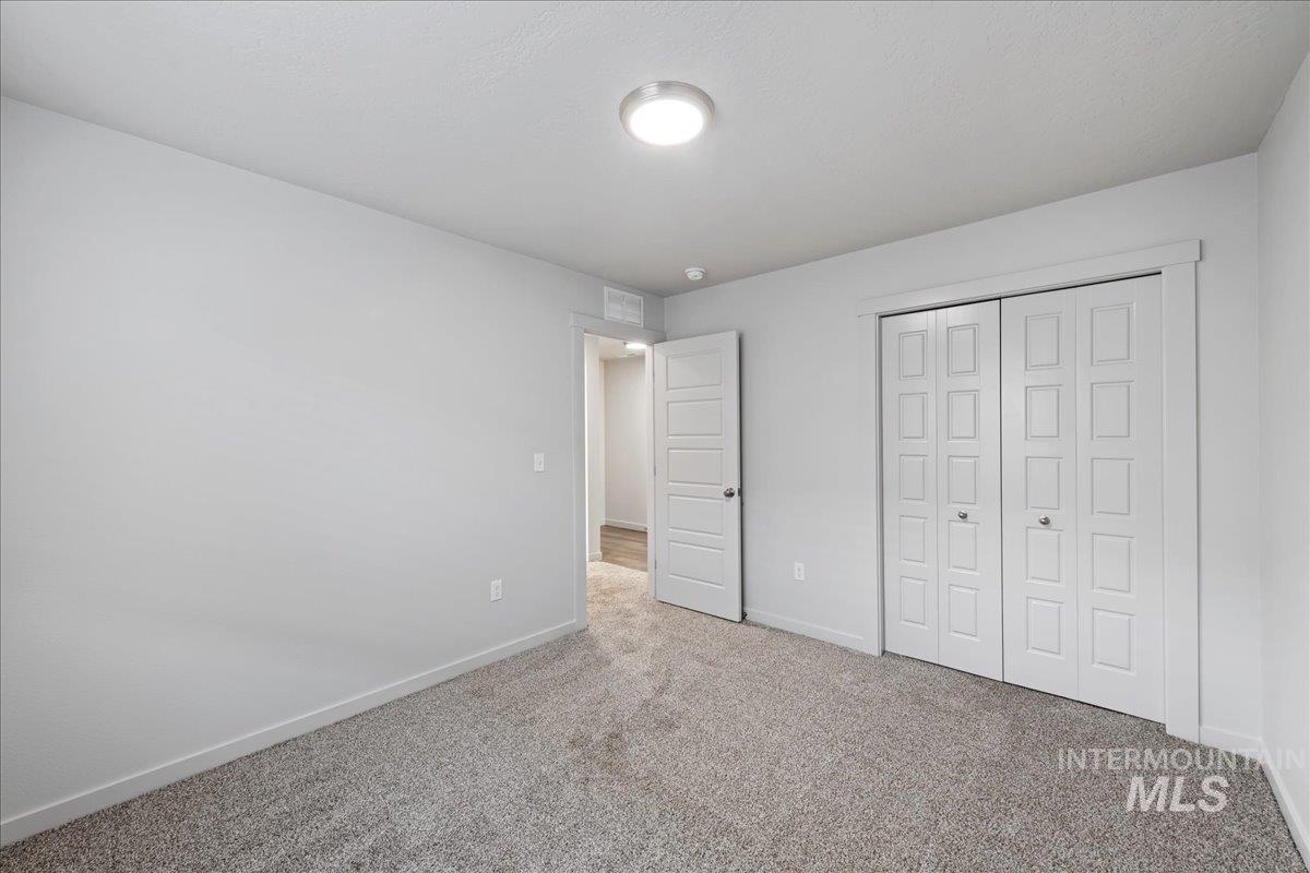 Unfurnished bedroom with carpet floors and a closet