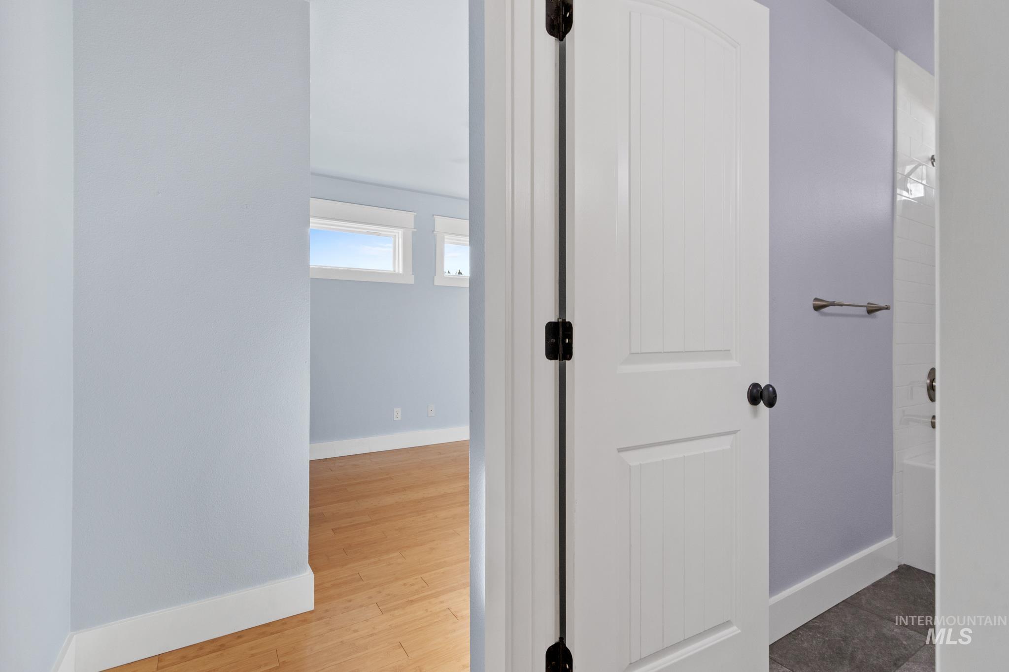 Hallway with baseboards and light wood-type flooring