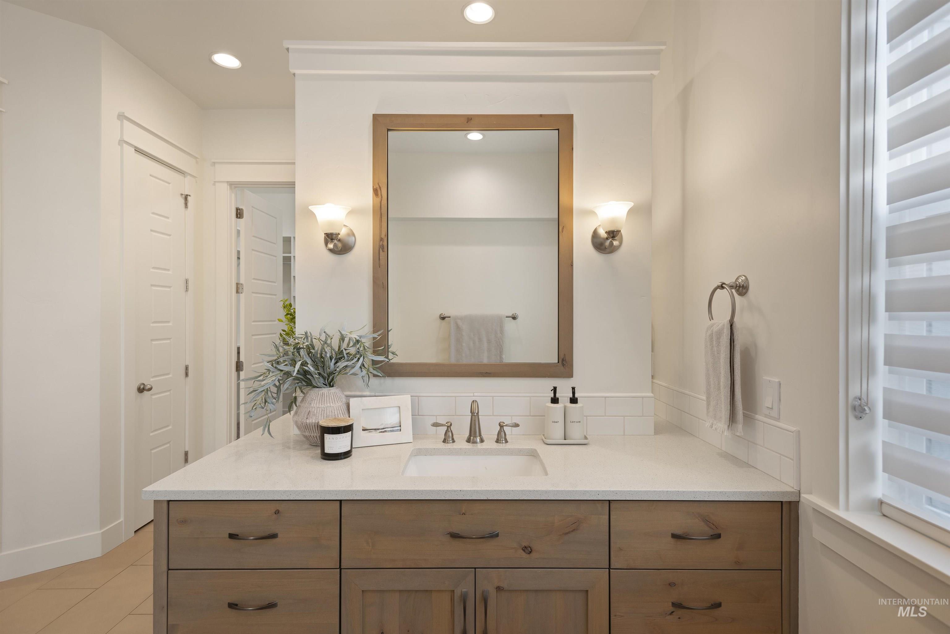 Bathroom featuring vanity and recessed lighting