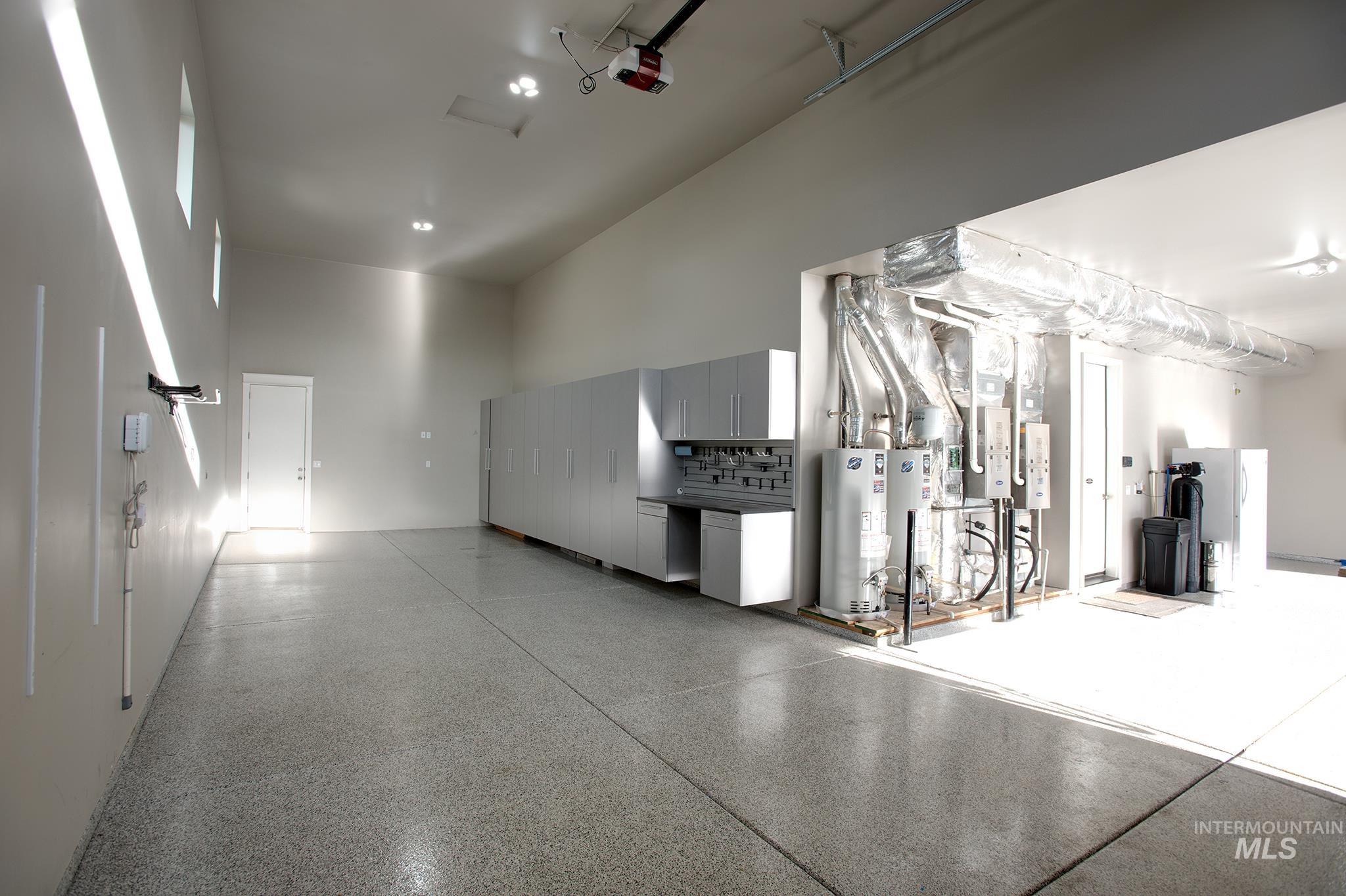 Garage with water heater and a garage door opener